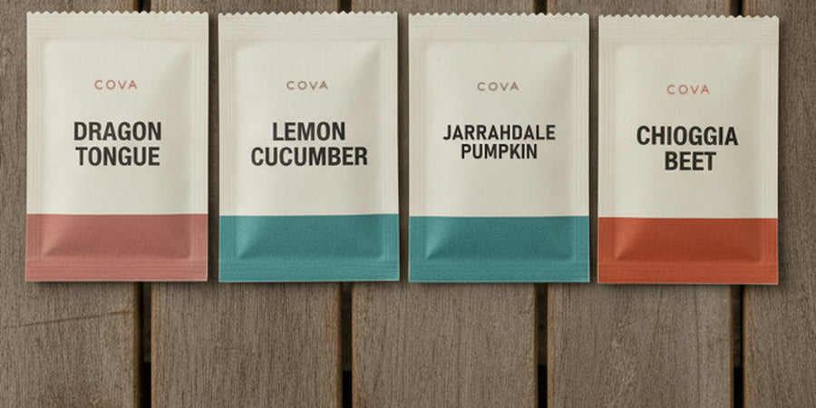 Labeled COVA seed packets laid out on a wooden table