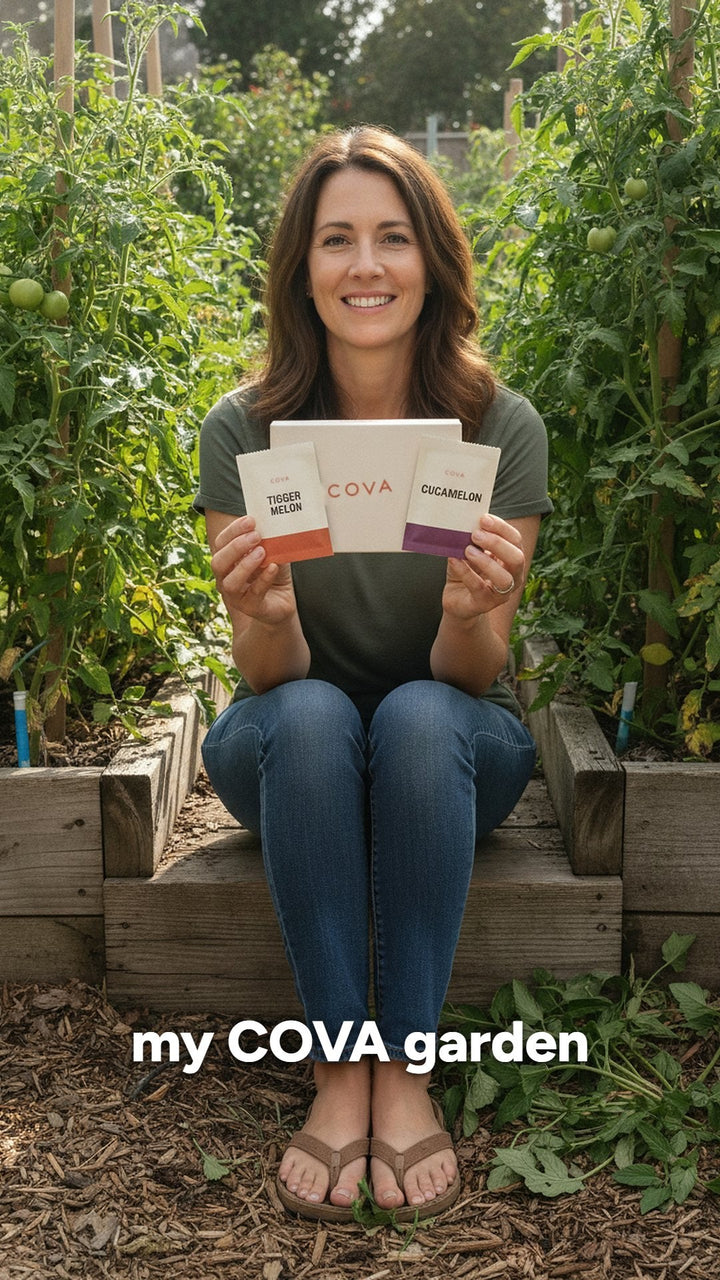 A customer in her backyard garden holding the COVA seed box and a seed packet