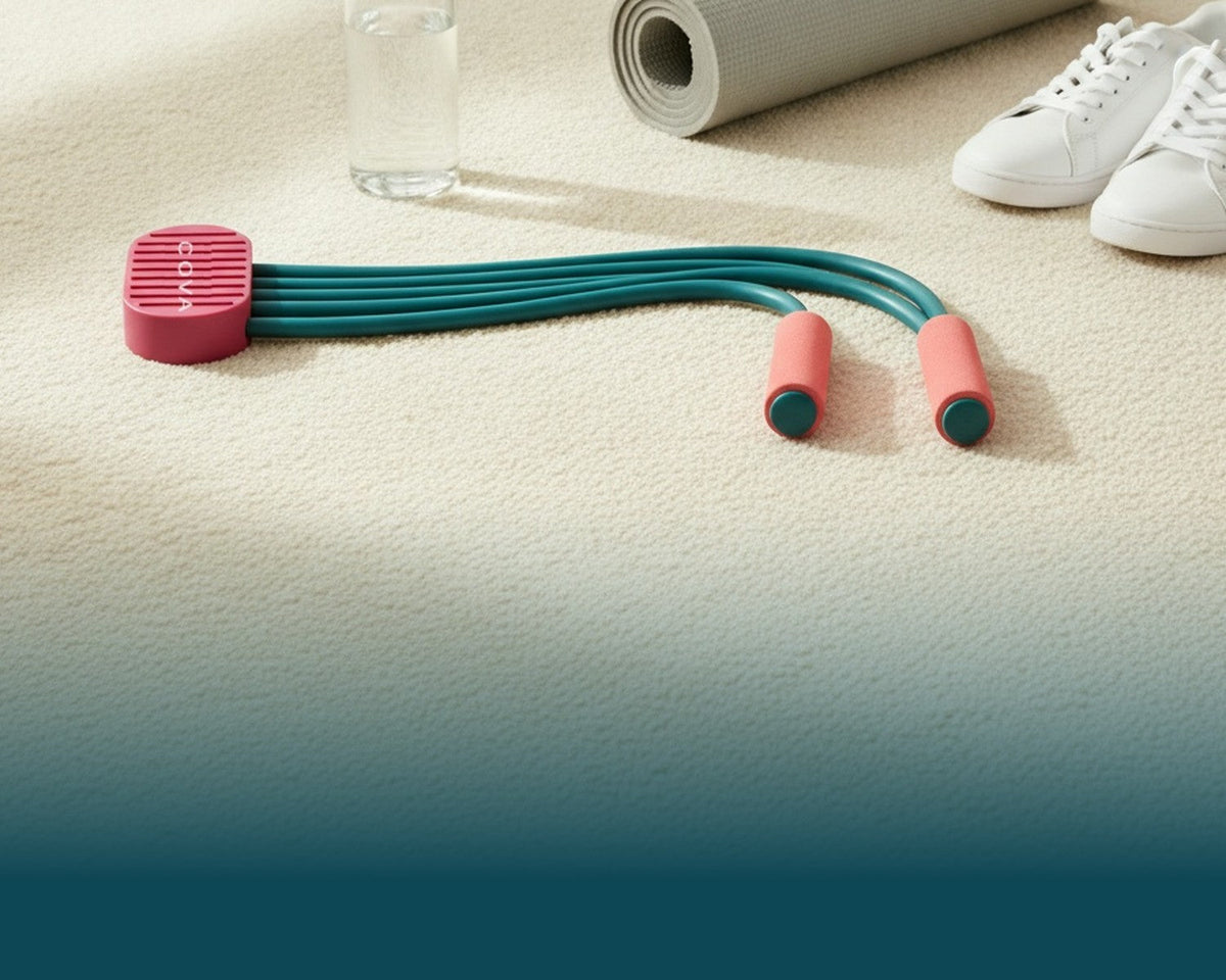 COVA pedal band laid out on a carpet next to a yoga mat, a water bottle and sneakers