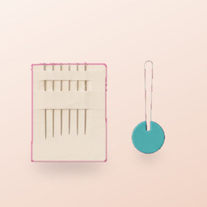 A pack of spare needles and a wire needle threader