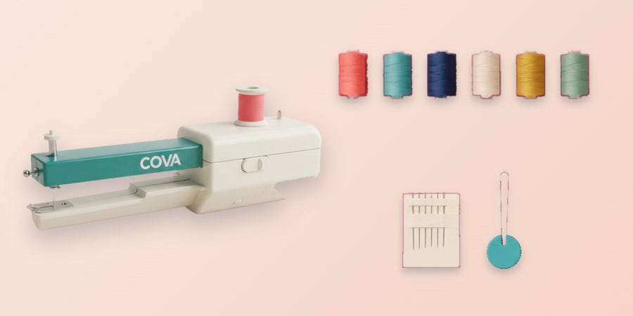 The handheld machine with six thread spools, spare needles and a needle threader