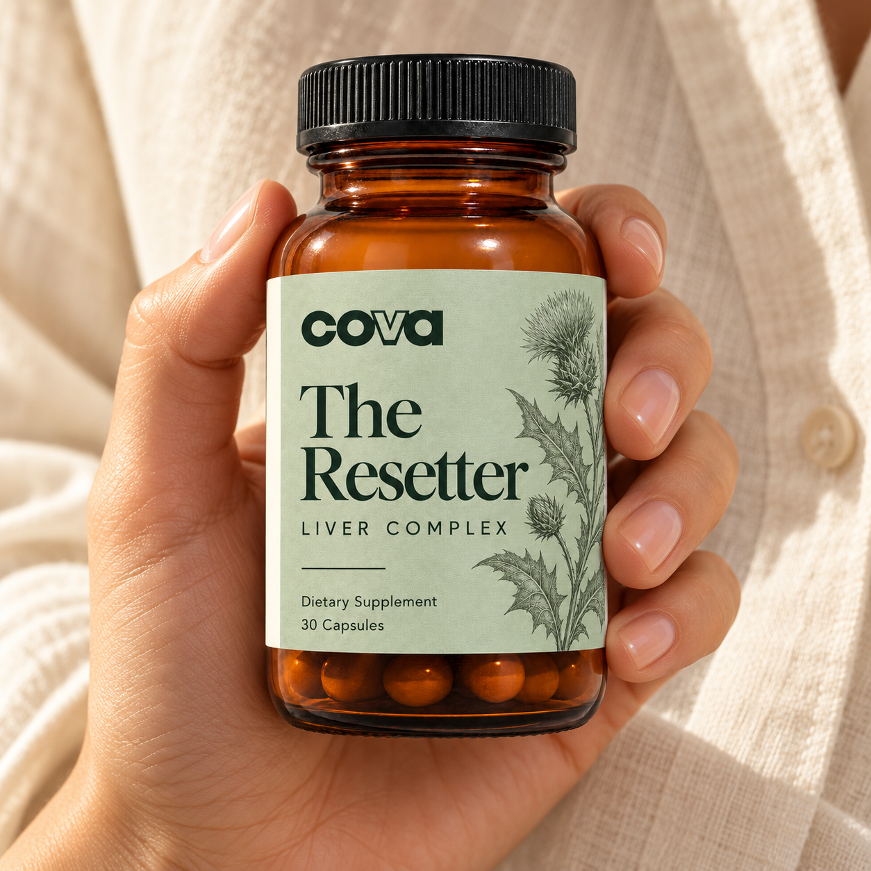 The Resetter amber bottle held in a hand